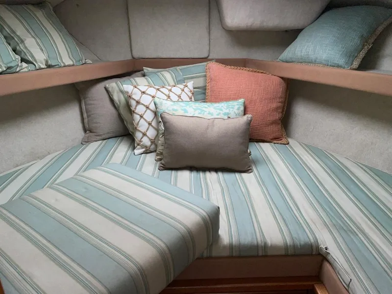 Slide: The Image of 1999 Bayliner 3388 Motoryacht cozy cabin with striped cushions and decorative pillows. - 38