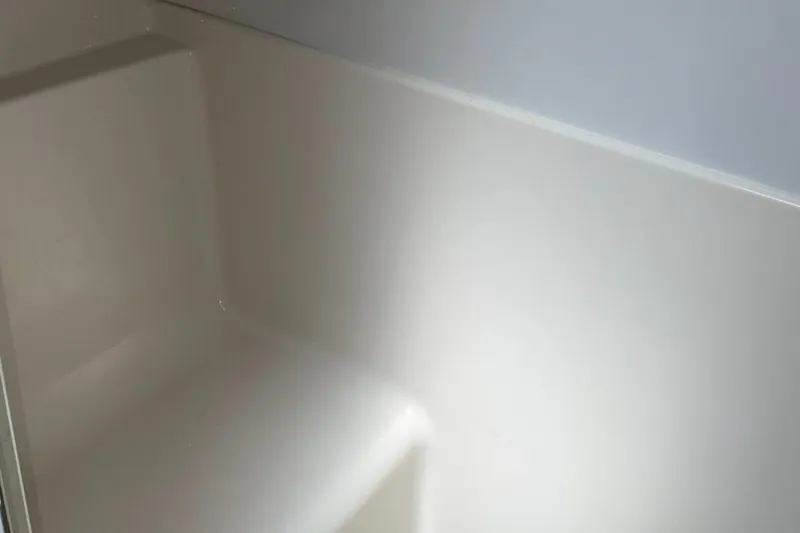 Slide: The Image of Interior of 1999 Bayliner 3388 Motoryacht, featuring a clean, white fiberglass surface. - 45