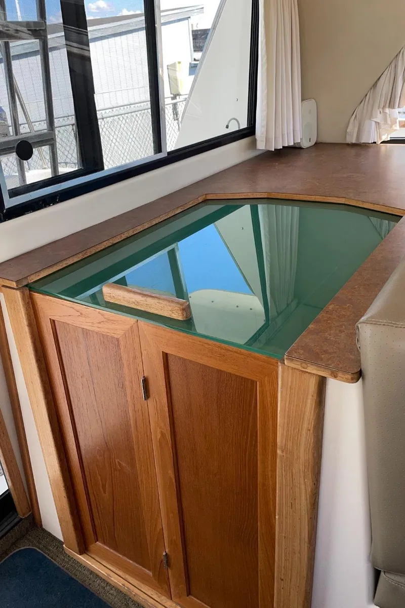 Slide: The Image of 1999 Bayliner 3388 Motoryacht interior with wooden cabinetry and glass countertop. - 46
