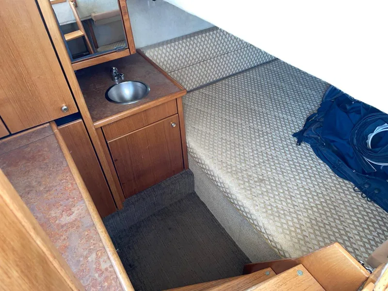 Slide: The Image of 1999 Bayliner 3388 Motoryacht interior cabin with sink and bed. - 47