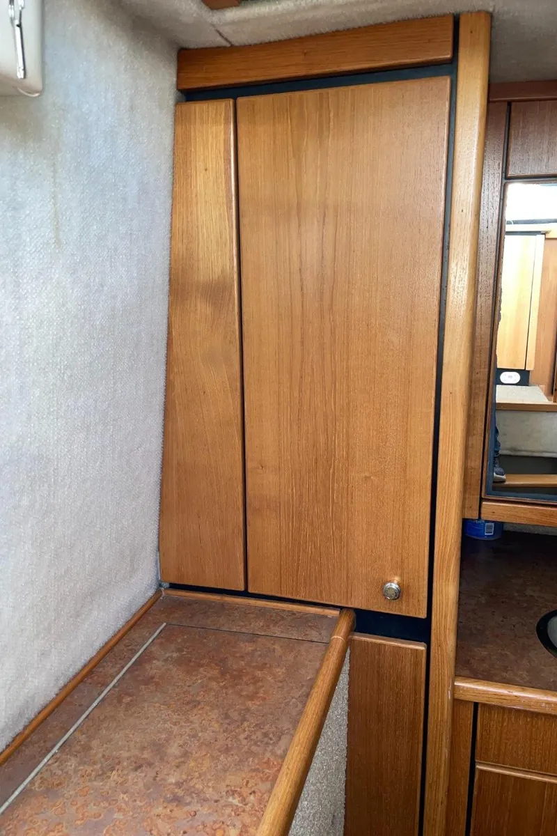 Slide: The Image of 1999 Bayliner 3388 Motoryacht interior wooden cabinet and countertop. - 49