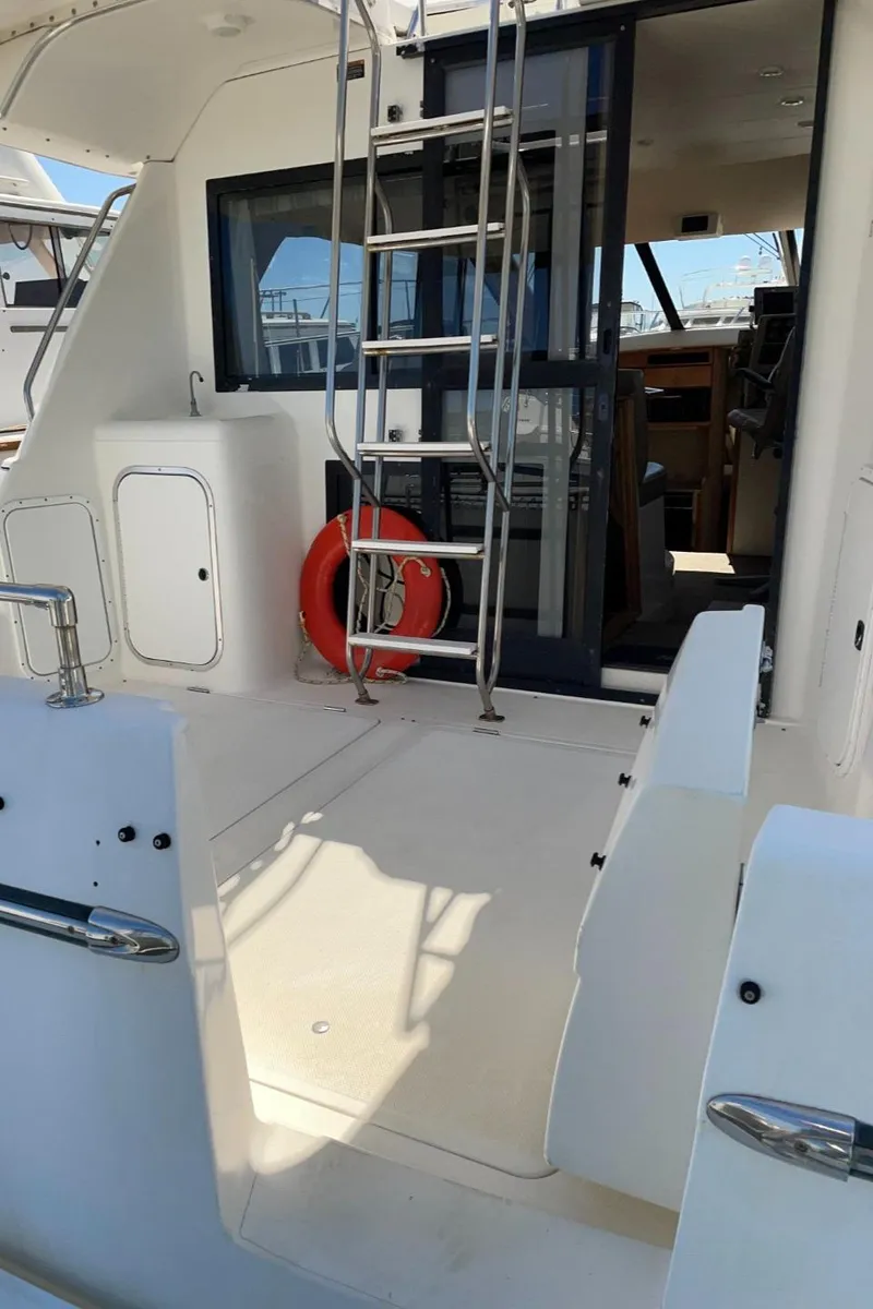 Slide: The Image of 1999 Bayliner 3388 Motoryacht deck with ladder and life preserver. - 6