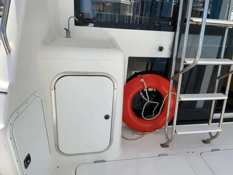Slide: The Image of 1999 Bayliner 3388 Motoryacht deck with life preserver and ladder. - 8
