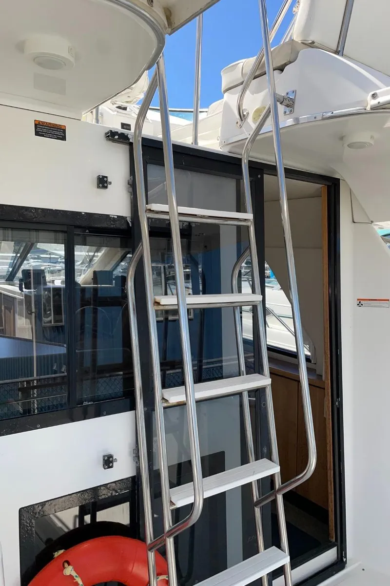 Slide: The Image of 1999 Bayliner 3388 Motoryacht with stainless steel ladder and cabin entrance. - 9