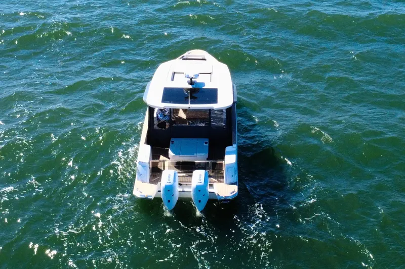 Slide: The Image of 2025 Saxdor 400 GTO boat on open water, rear view with dual engines. - 14