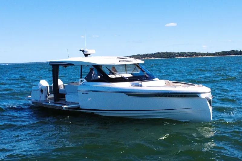 Slide: The Image of 2025 Saxdor 400 GTO luxury boat cruising on open water. - 2