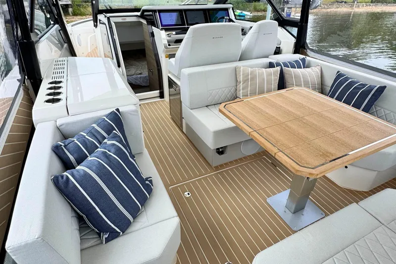 Slide: The Image of 2025 Saxdor 400 GTO boat interior with clear enclosure and seating area. - 20