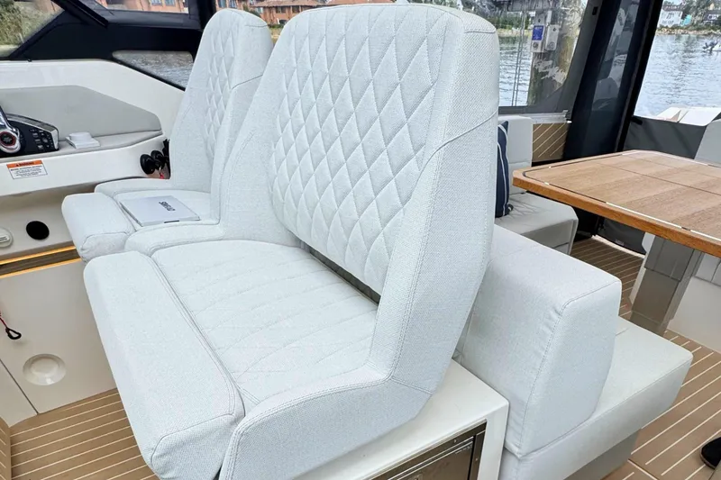 Slide: The Image of Interior of 2025 Saxdor 400 GTO yacht with modern seating and scenic water view. - 28
