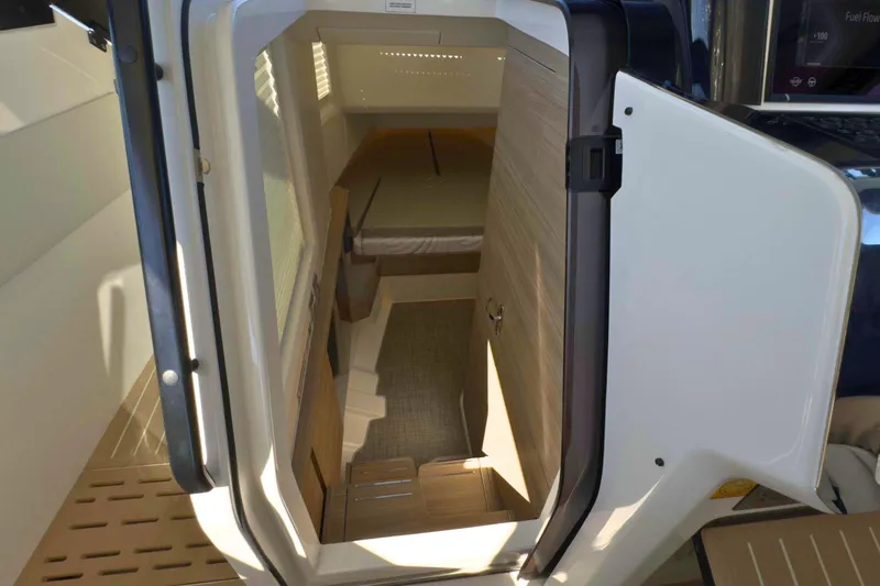 Slide: The Image of 2025 Saxdor 400 GTO boat interior with open cabin door, sleek design, and scenic water view. - 38