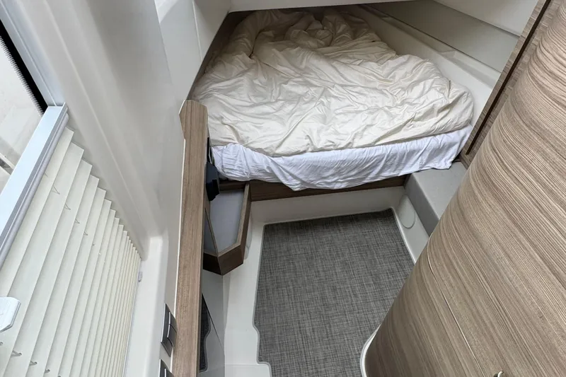 Slide: The Image of 2025 Saxdor 400 GTO boat interior with wooden deck and cozy cabin bed. - 39