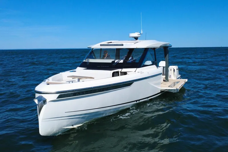 Slide: The Image of 2025 Saxdor 400 GTO boat cruising on a sunny, scenic ocean. - 4