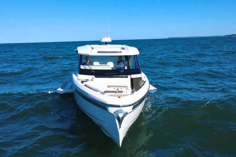 Slide: The Image of 2025 Saxdor 400 GTO boat cruising on open sea under clear blue sky. - 5