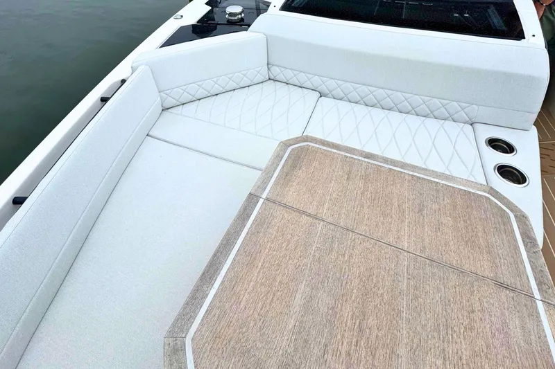Slide: The Image of 2025 Saxdor 400 GTO yacht with sleek design and wooden deck table on calm water. - 55