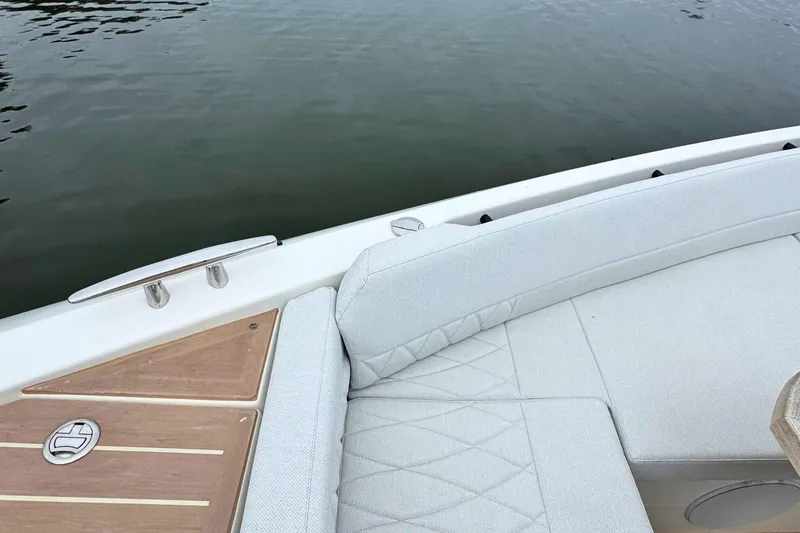 Slide: The Image of Luxurious seating area on 2025 Saxdor 400 GTO boat with wooden table and cup holders. - 56