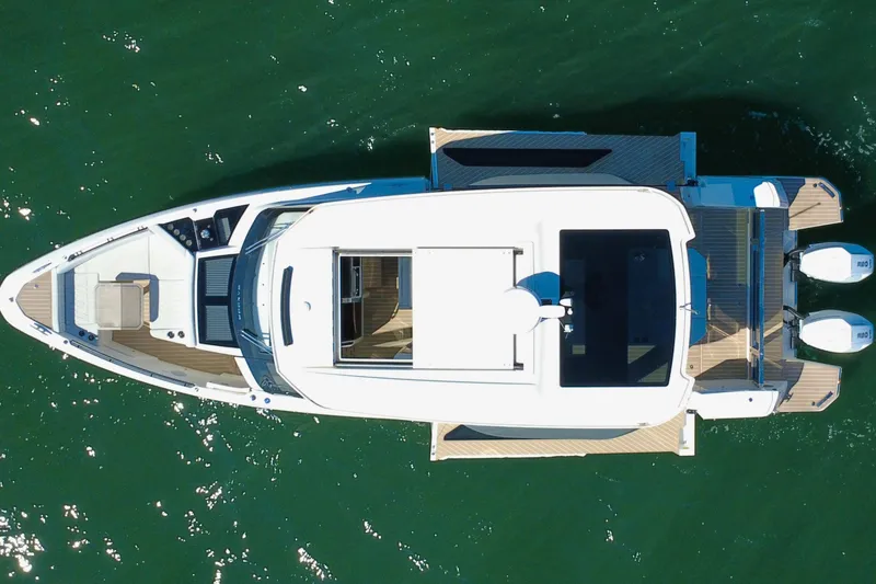 Slide: The Image of 2025 Saxdor 400 GTO boat on open water, rear view with dual engines. - 7