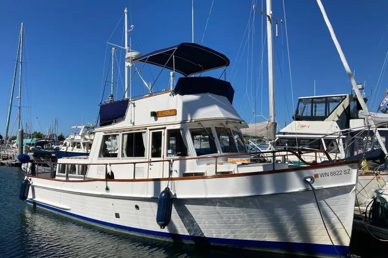 The Image of 1984 Grand Banks 36 Classic yacht docked in a marina under clear blue skies. - 0