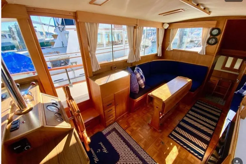 Slide: The Image of Interior of 1984 Grand Banks 36 Classic yacht with wooden furnishings and blue seating. - 11