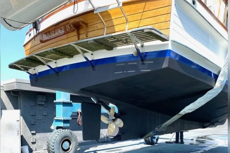 Slide: The Image of 1984 Grand Banks 36 Classic yacht in dry dock, showcasing hull and propeller. - 12
