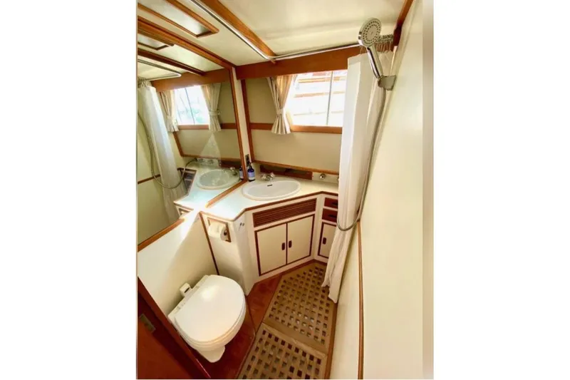 Slide: The Image of 1984 Grand Banks 36 Classic yacht bathroom with shower, sink, and toilet. - 13