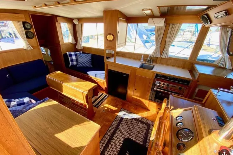 Slide: The Image of Interior of 1984 Grand Banks 36 Classic yacht with wood finish and cozy seating. - 16