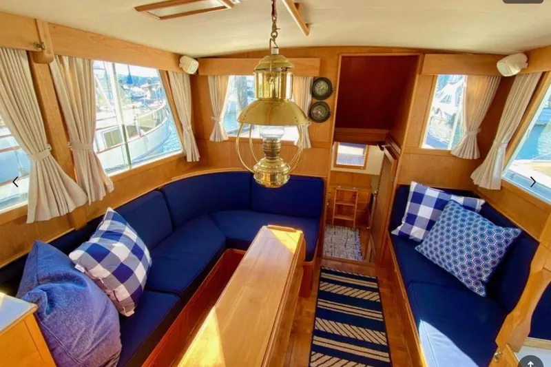 Slide: The Image of Interior of 1984 Grand Banks 36 Classic yacht with blue seating and nautical decor. - 3