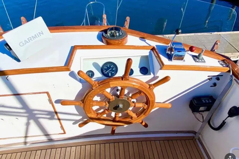 Slide: The Image of Helm of 1984 Grand Banks 36 Classic yacht with wooden wheel and Garmin navigation. - 4