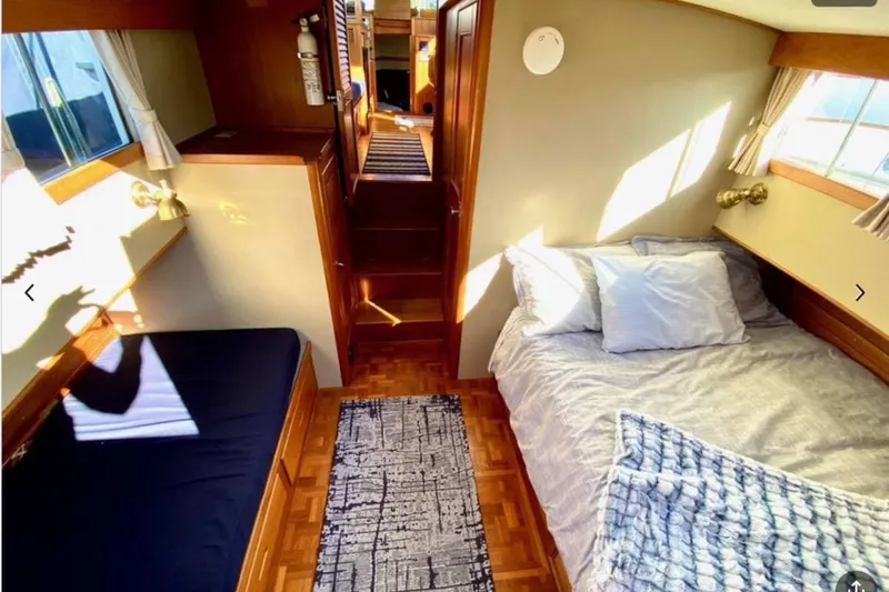 Slide: The Image of Cozy cabin interior of 1984 Grand Banks 36 Classic yacht with beds and wooden decor. - 5