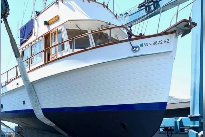 Slide: The Image of 1984 Grand Banks 36 Classic yacht on a lift, showcasing its elegant design. - 8