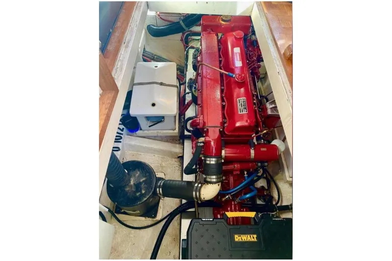 Slide: The Image of Engine compartment of a 1984 Grand Banks 36 Classic boat, featuring a red engine. - 9
