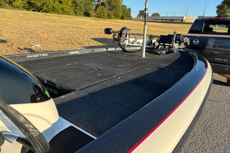 Slide: The Image of 2011 Skeeter ZX250 boat interior with Lowrance navigation system, parked on a sunny day. - 10