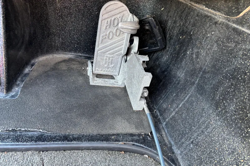 Slide: The Image of 2011 Skeeter ZX250 bass boat on trailer, parked outdoors under clear blue sky. - 25