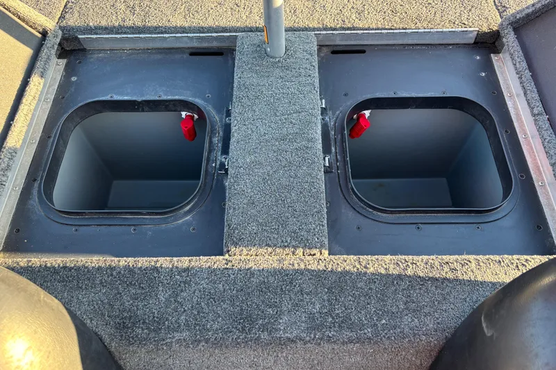Slide: The Image of Open storage compartment on a 2011 Skeeter ZX250 boat, featuring carpeted interior. - 30