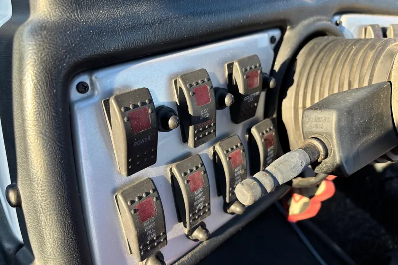 Slide: The Image of 2011 Skeeter ZX250 boat storage compartments with open lids, featuring carpeted surfaces. - 31