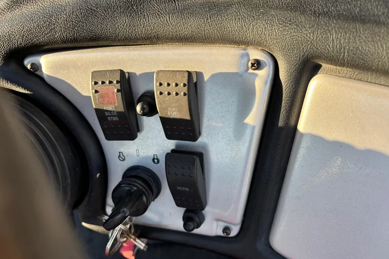 Slide: The Image of Control panel of a 2011 Skeeter ZX250 boat with multiple switches. - 32