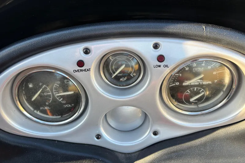 Slide: The Image of Control panel of a 2011 Skeeter ZX250 boat with switches and ignition keys. - 33