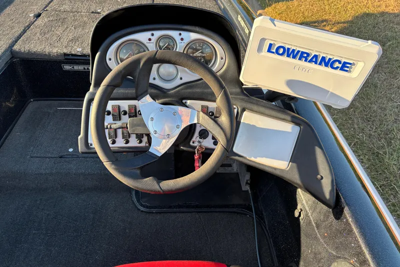 Slide: The Image of Storage compartment of a 2011 Skeeter ZX250 boat, featuring a latch mechanism. - 37