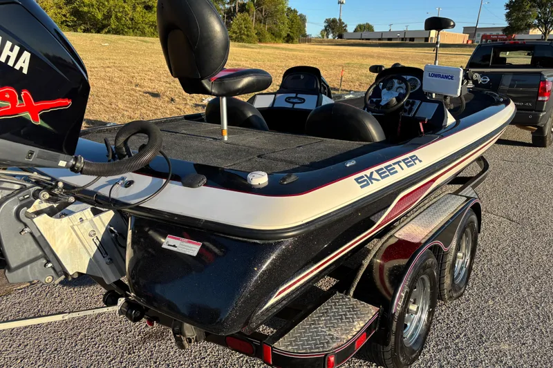 Slide: The Image of 2011 Skeeter ZX250 boat with Yamaha engine on a trailer, parked outdoors. - 5