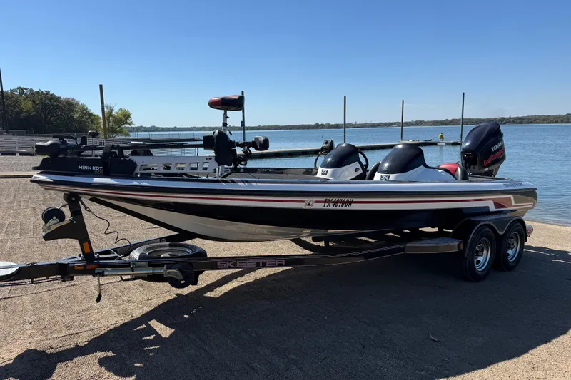 Slide: The Image of 2011 Skeeter ZX250 boat on trailer by a lake, ready for fishing. - 54