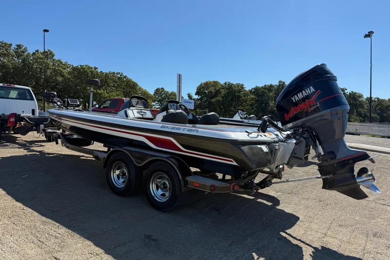 Slide: The Image of 2011 Skeeter ZX250 boat with Yamaha VMAX engine on trailer in sunny outdoor setting. - 59