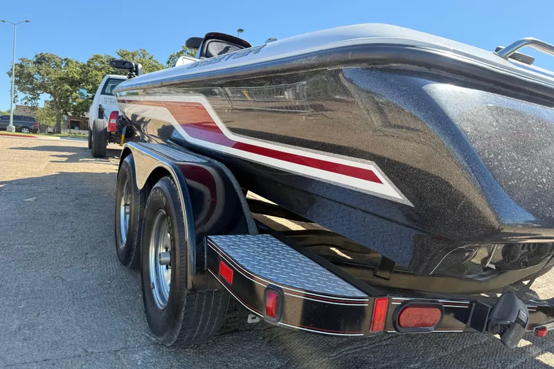 Slide: The Image of 2011 Skeeter ZX250 boat on trailer, featuring sleek design and dual wheels. - 61