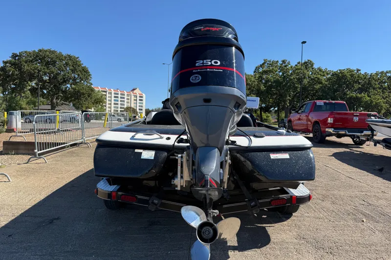 Slide: The Image of 2011 Skeeter ZX250 boat with Yamaha 250 engine, parked outdoors on a sunny day. - 62