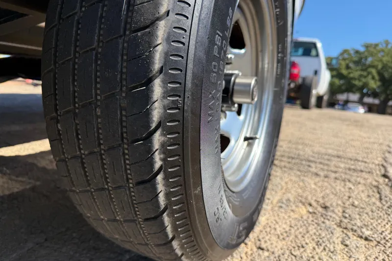 Slide: The Image of Close-up of a 2011 Skeeter ZX250 trailer tire on a sunny day. - 67