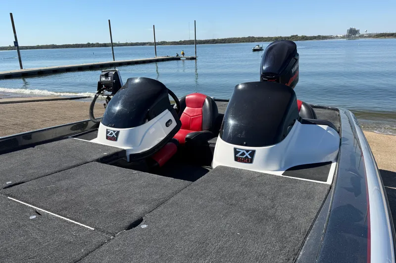 Slide: The Image of 2011 Skeeter ZX250 boat with Yamaha engine at a lakeside dock. - 75