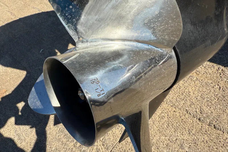 Slide: The Image of Close-up of a 2011 Skeeter ZX250 boat propeller on concrete surface. - 79