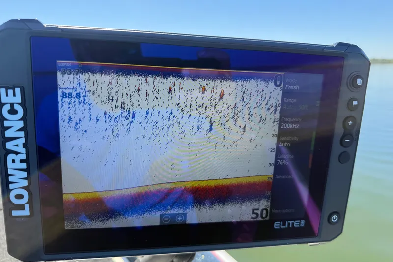 Slide: The Image of Lowrance Elite fish finder on 2011 Skeeter ZX250, displaying sonar data on a sunny day. - 89