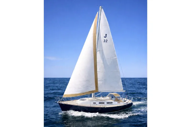 The Image of 2001 J Boats J/32 sailboat navigating open sea under clear blue sky. - 0