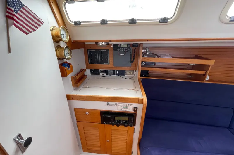 Slide: The Image of 2001 J Boats J/32 interior with navigation station, instruments, and seating area. - 14