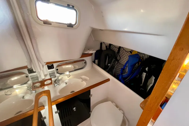 Slide: The Image of 2001 J Boats J/32 yacht bathroom with sink, mirror, and storage area. - 15