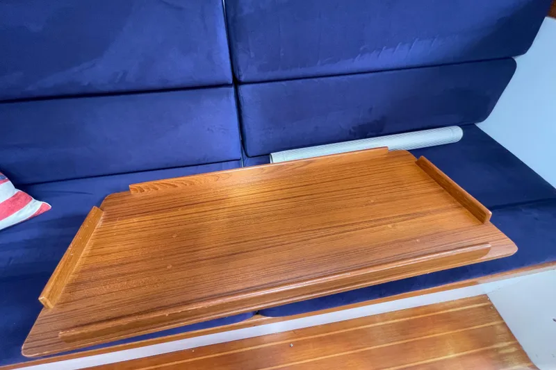 Slide: The Image of Wooden table on a 2001 J Boats J/32 yacht with blue seating. - 18