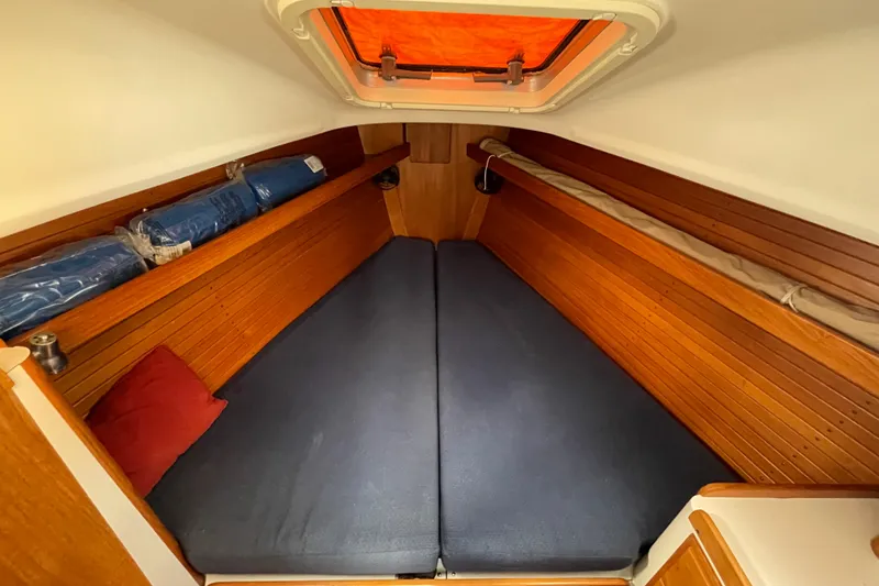 Slide: The Image of Cozy cabin interior of 2001 J Boats J/32 with wooden paneling and blue cushions. - 19